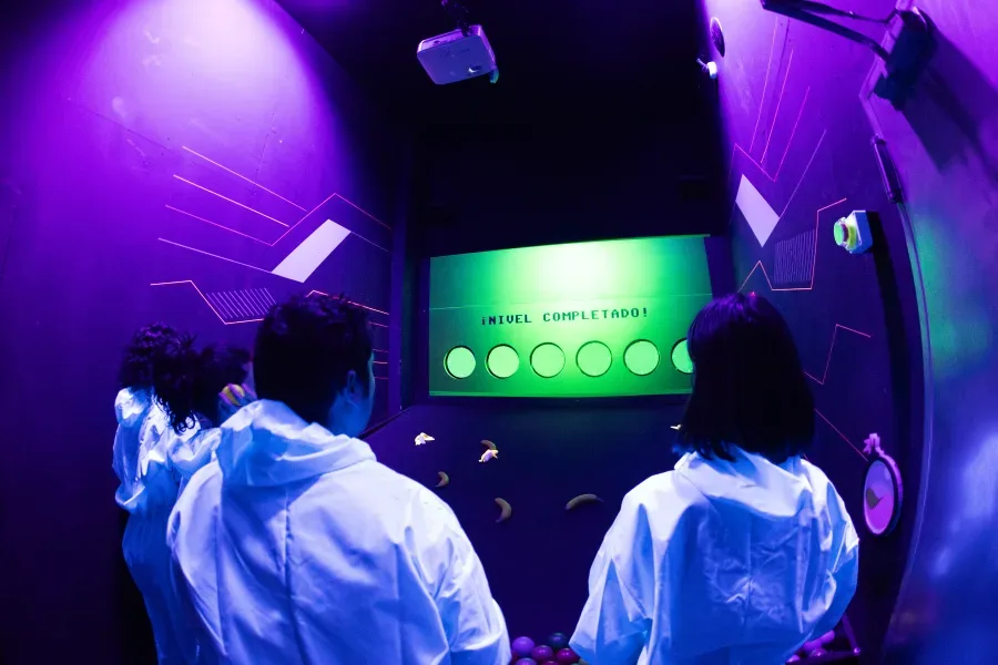 Players taking on a Boom Lab challenge under coloured lights